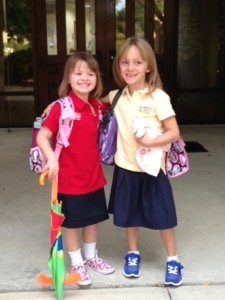 Lenox and friend Delilah in front of school - right before she peaked a fever.