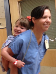 Lenox getting a piggy back ride from her oncologist as they head into OR for spinal chemo. You can see how much they enjoy each other and how much Lenox trusts her. 